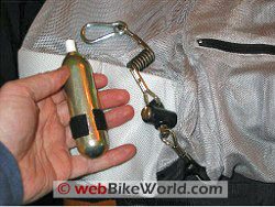 Motorcycle airbag jacket inflation device.