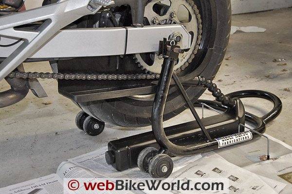 Chain Drain - Chain Drain placed between rear swingarm stand and rear wheel. Note backsplash under chain.