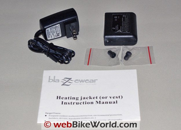 Clockwise from top left: Blazewear Heated Vest battery charger, battery, protection plugs, owner's manual.