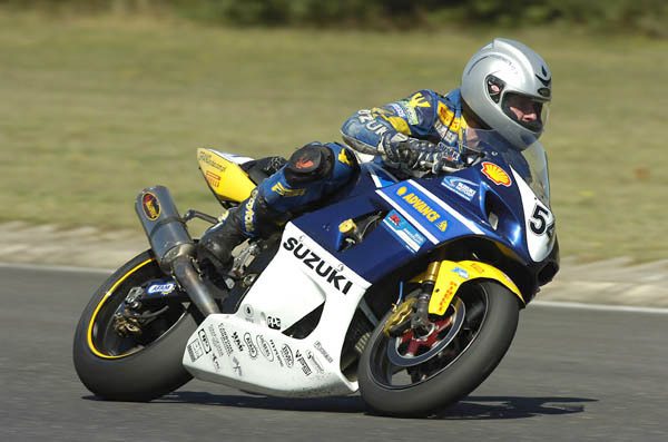 Motorcycle racer using a Reevu MSX1 helmet