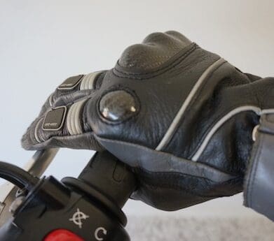 Fingers wresting on the brake lever and around the throttle