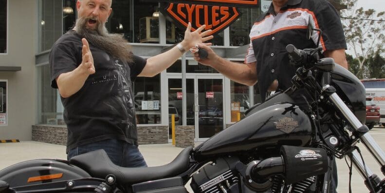 Garry "Gaz" Luxmoore hands over the keys to a Low Rider S to surprised winner Brett Humphries