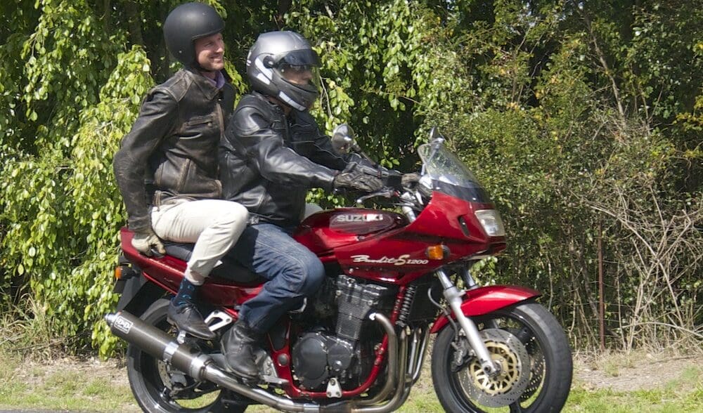 RACQ spokesman Steve Spalding takes Road Safety Minister Mark Bailey for a ride on his Bandit national encourages