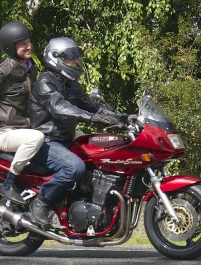 RACQ spokesman Steve Spalding takes Road Safety Minister Mark Bailey for a ride on his Bandit national encourages