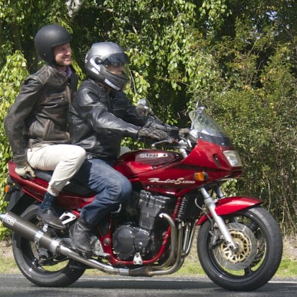 RACQ spokesman Steve Spalding takes Road Safety Minister Mark Bailey for a ride on his Bandit national encourages