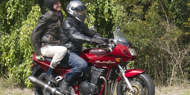 RACQ spokesman Steve Spalding takes Road Safety Minister Mark Bailey for a ride on his Bandit national encourages