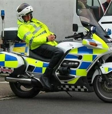 Cop asleep on motorcycle extended