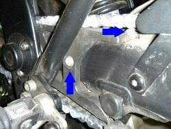 Location of the two Torx bolts that hold the rubber chain guard.