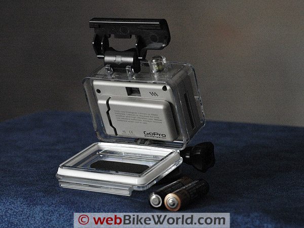 The GoPro Wide in its waterproof housing, with two AAA batteries in the foreground.