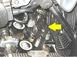 Valve adjusting tool over cam