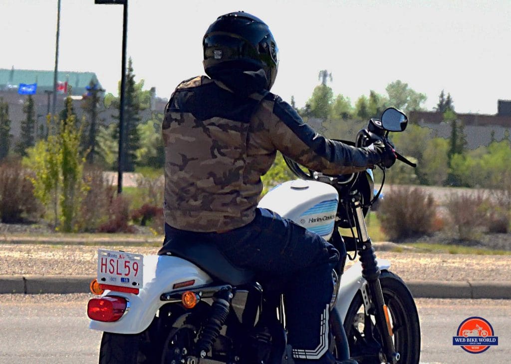 Rider in Camo on top Harley Davidson Motorcycle