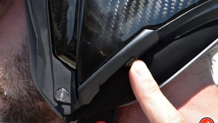 The sliding switch on the helmet for extending or retracting the sun lens.