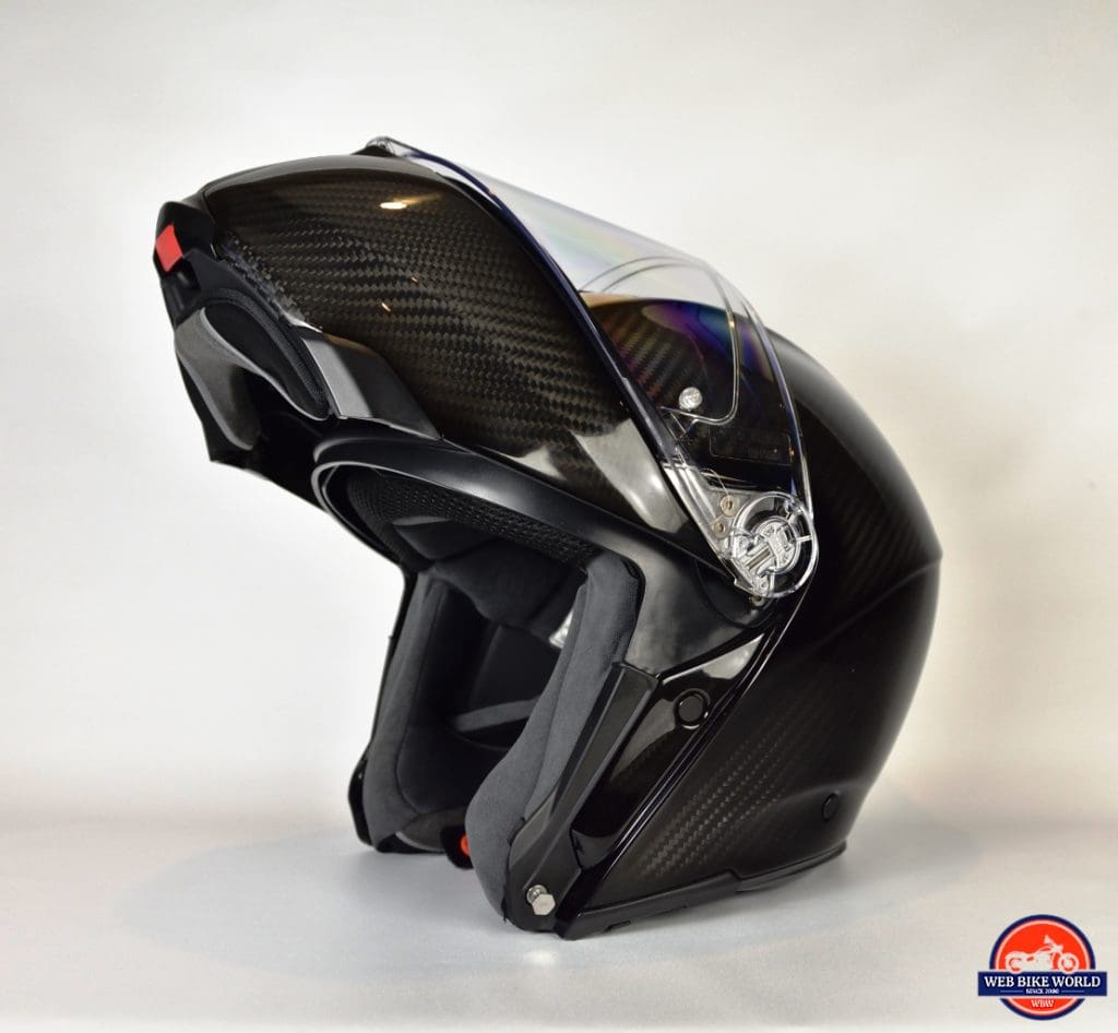 AGV Sportmodular Carbon Gloss helmet chinbar raised, sun lens lowered from the left side.