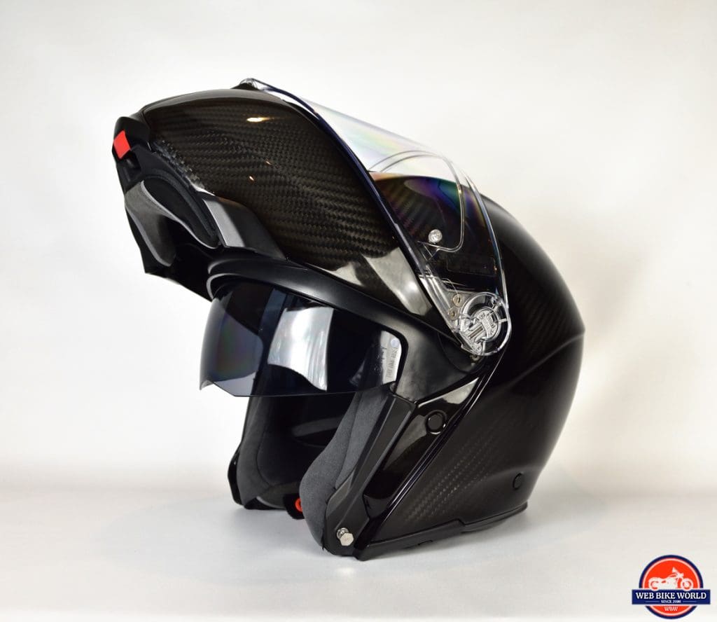 AGV Sportmodular Carbon Gloss helmet chinbar raised and sun lens retracted.