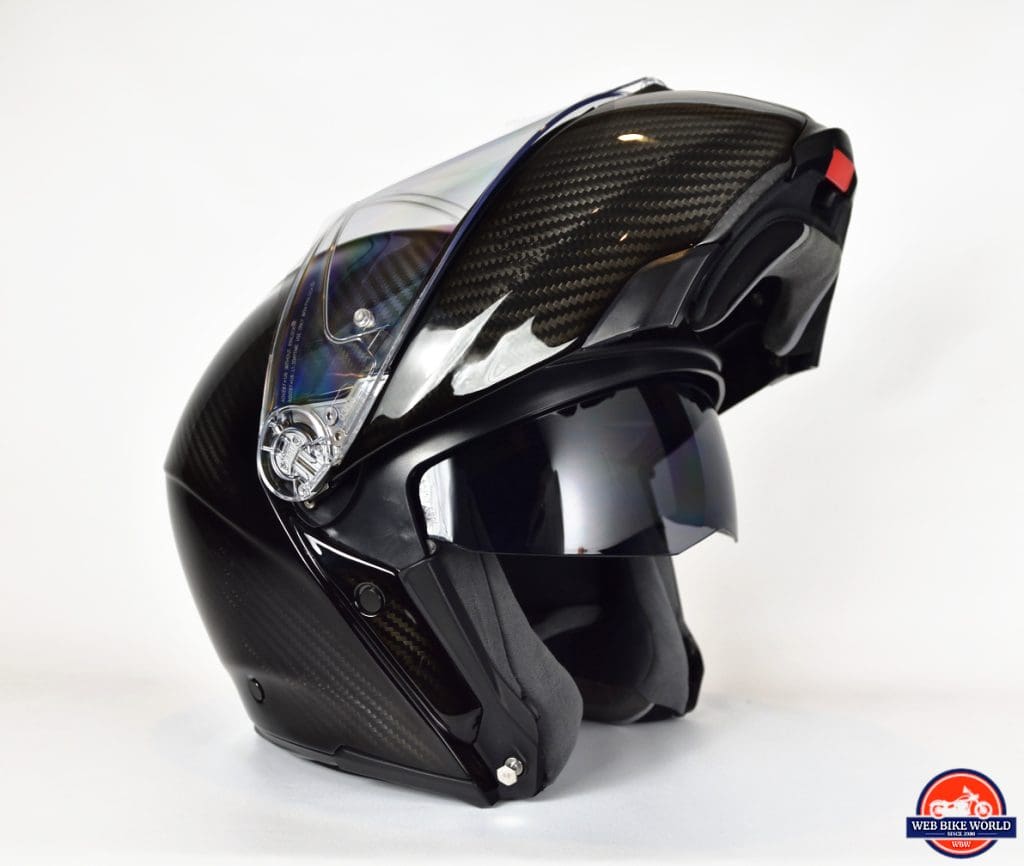 AGV Sportmodular Carbon Gloss helmet with chinbar raised and sun lens lowered.