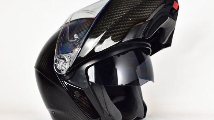 AGV Sportmodular Carbon Gloss helmet with chinbar raised and sun lens lowered.