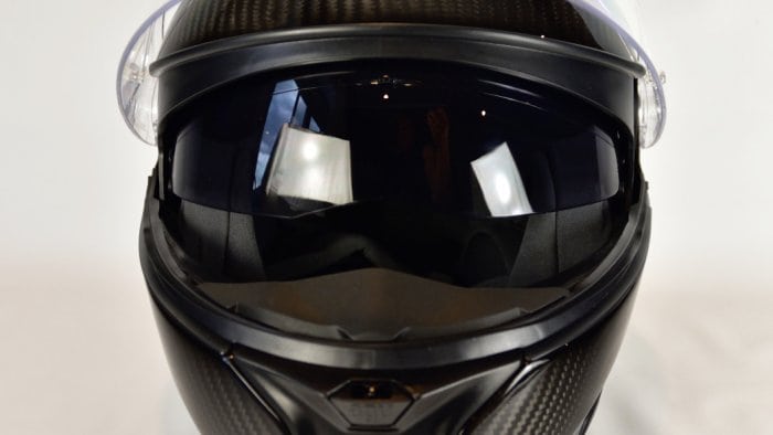 AGV Sportmodular Carbon Gloss helmet with chinbar lowered and sun lens lowered.