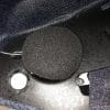 Speaker attached to velcro tab in helmet