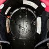 Speakers both attached to helmet and wire running across the crown of the helmet