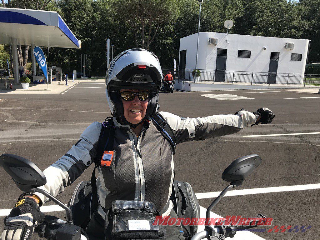 Victoria Zandonella gives hand signal to allow motorcyclists to pass