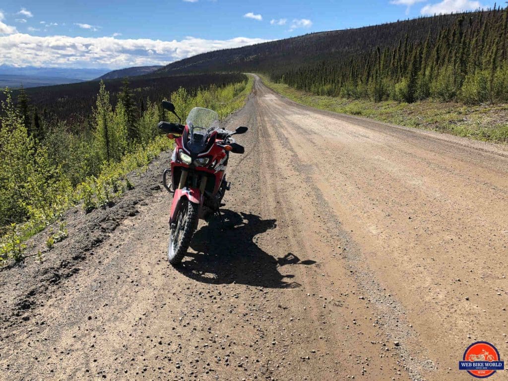 An Africa Twin overlooking the Ogilvie Ridge on the Dempster Highway.