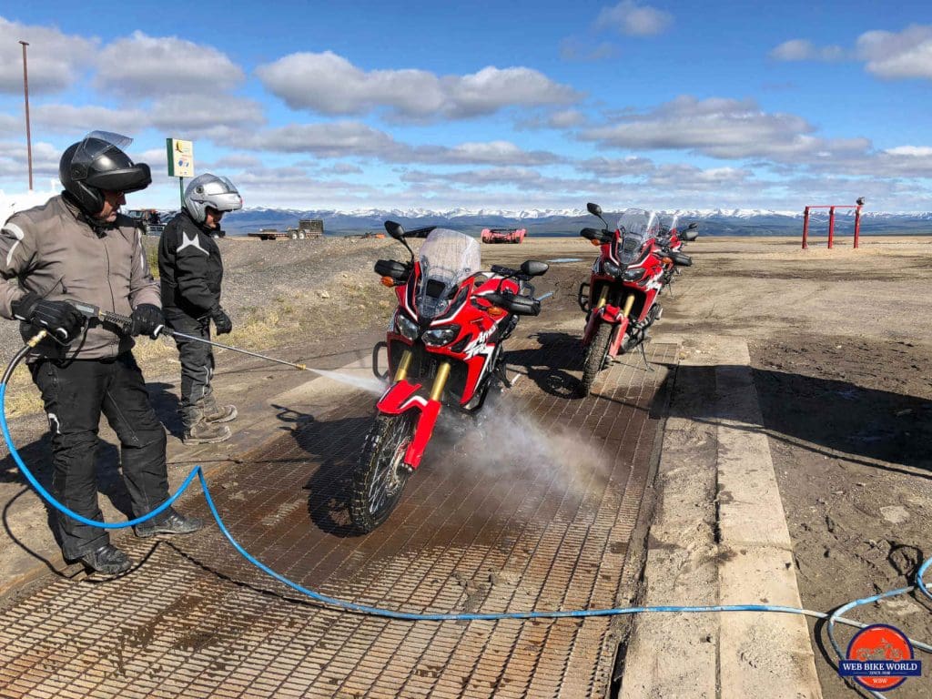 Washing the Africa Twins at the Eagle Plains Motel on the Dempster Highway.