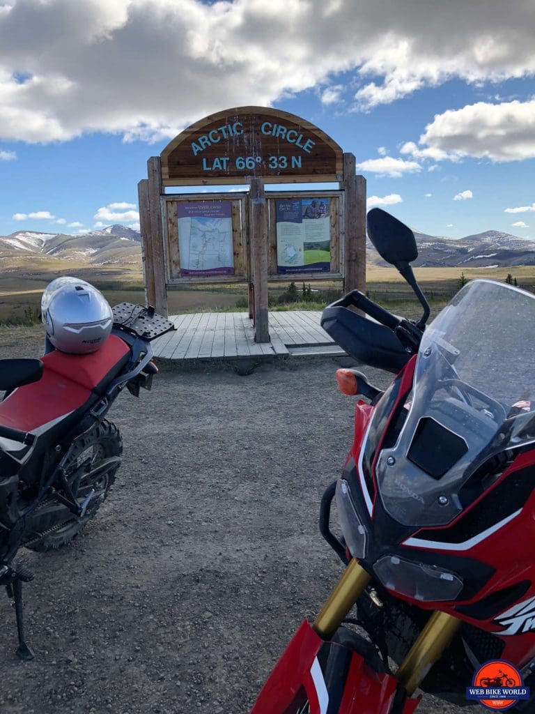 The Africa Twins at the Arctic Circle marker on the Dempster Highway.