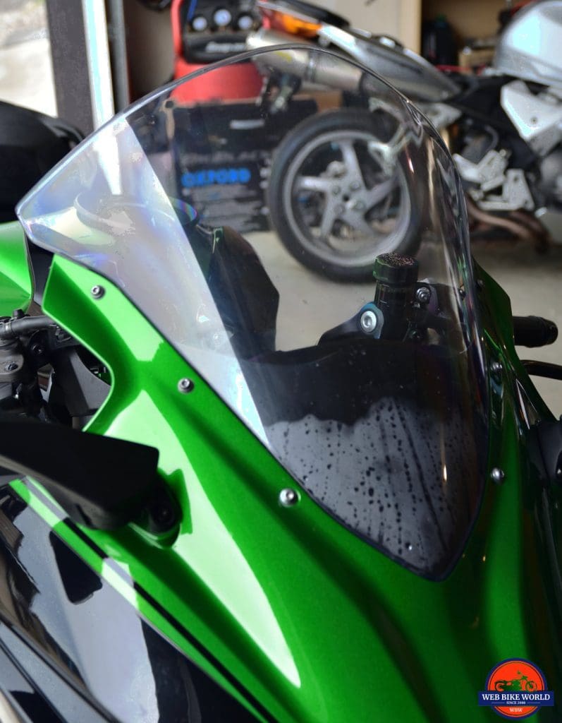 Moisture trapped behind the windshield of a 2018 Kawasaki Ninja H2SXSE.