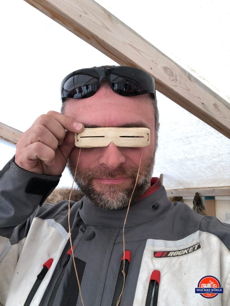 Me wearing Inuit sunglasses in Tuk.