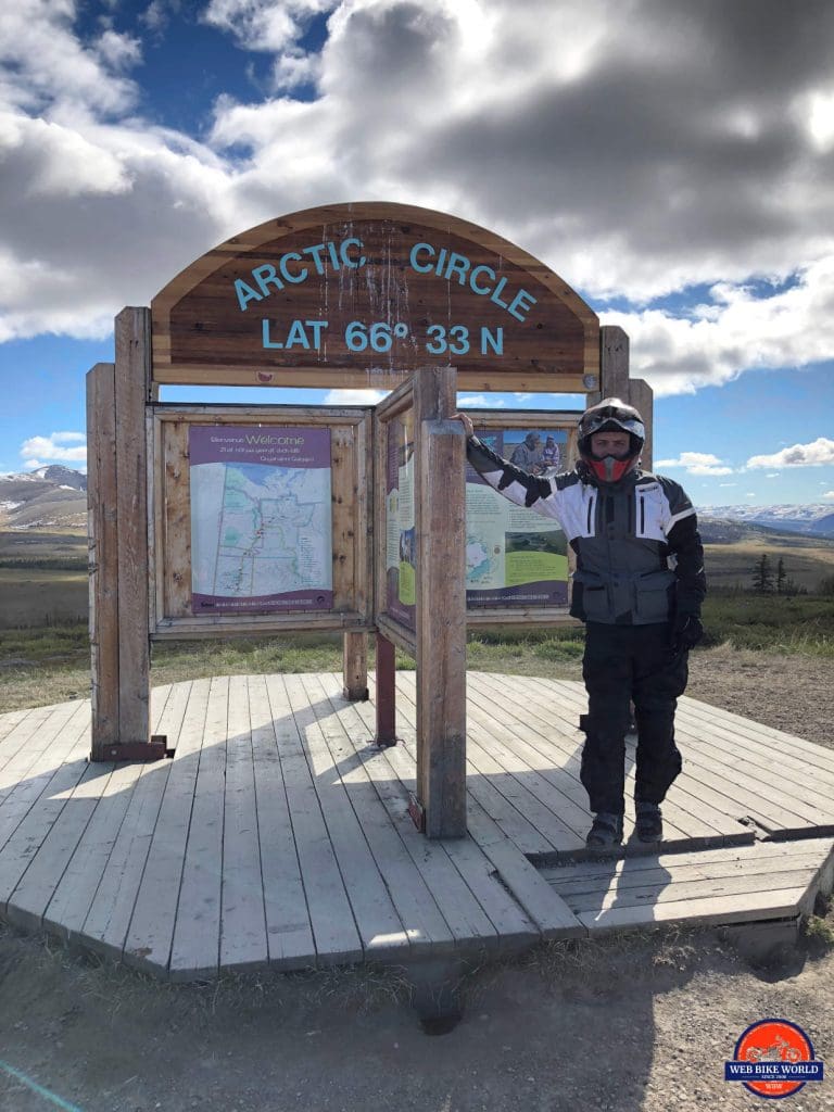 Me standing at the marker for the Arctic Circle on the Dempster Highway.