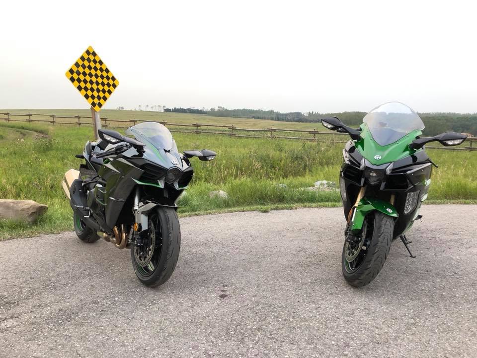 The Kawasaki H2 and H2SX SE together in a parking lot.