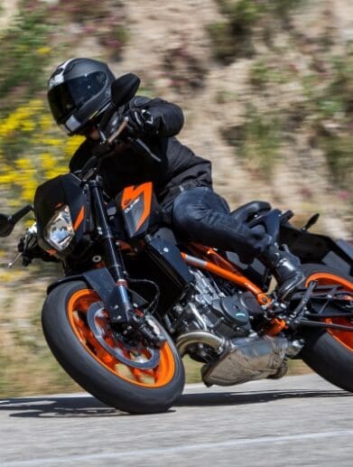 A KTM duke leans into a right turn.