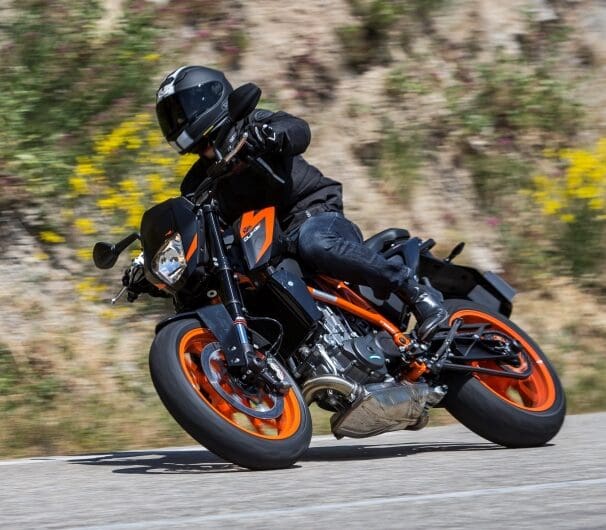 A KTM duke leans into a right turn.