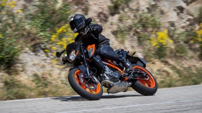 A KTM duke leans into a right turn.