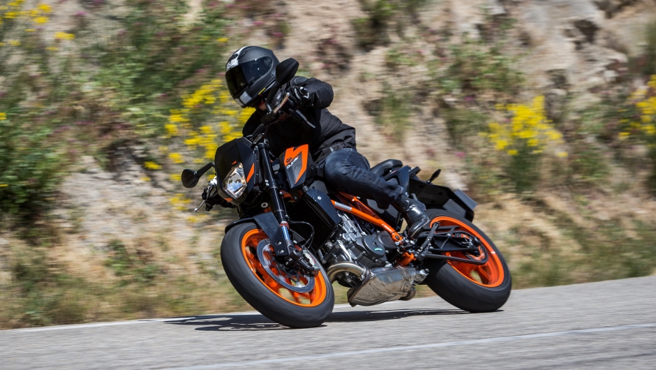 A KTM duke leans into a right turn.