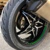 A new Road 5 tire installed on the rear of a Kawasaki H2SX SE.