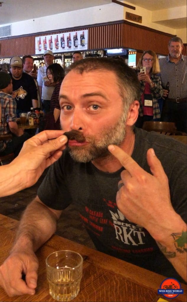 Me joining the Sourtoe Cocktail club by kissing a mummified human toe. In the Sourdough Saloon, Dawson City.