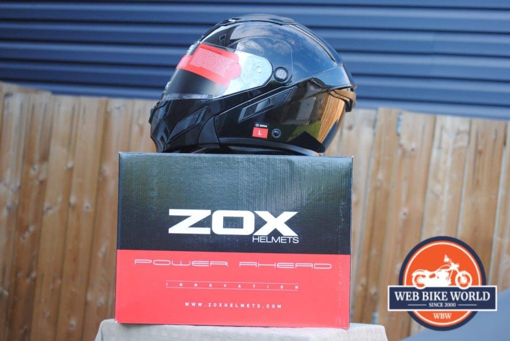 ZOX Brigade SVS Solid Helmet on top of Zox box