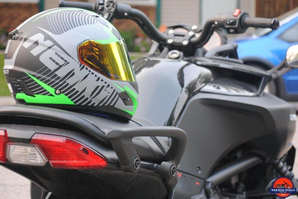 NENKI NK856 Helmet resting on Motorcycle