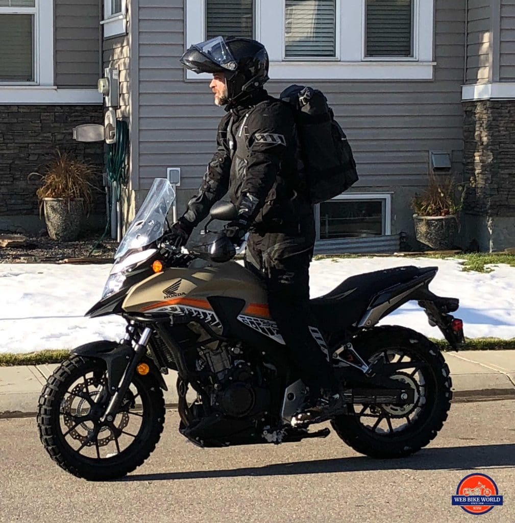 Me riding a Honda CB500X wearing a Velomacchi 40L Speedway Backpack.