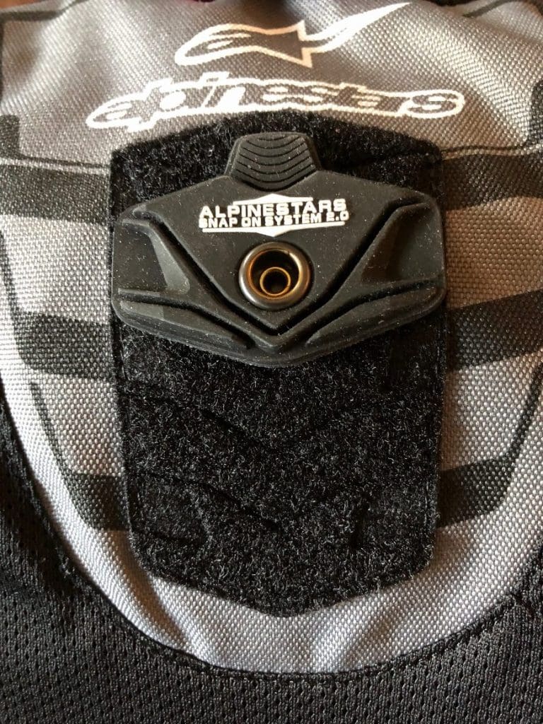 Alpinestars velcro and snap back protector attachment system