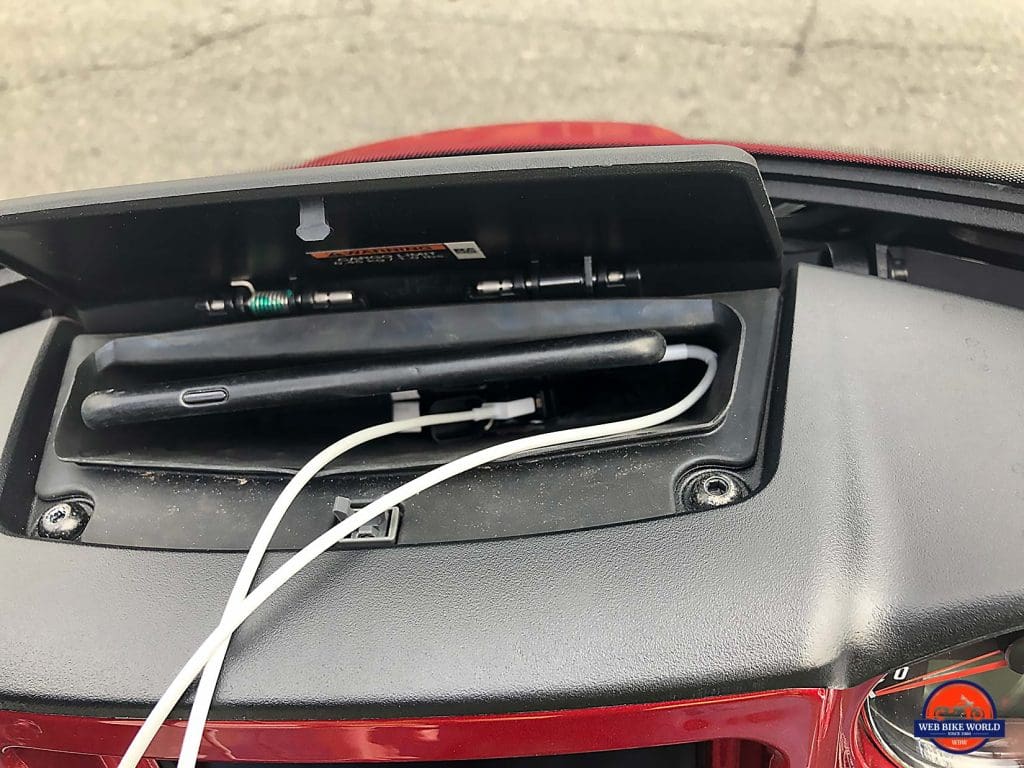 Indian Chieftain Ltd cell phone storage compartment with an iPhone 8 in it.