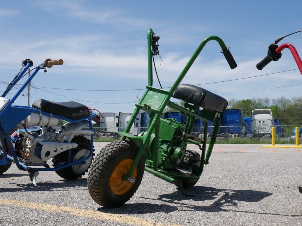 green minibike parked at pull start racing league event