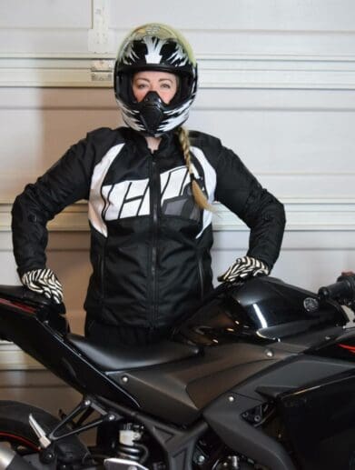 ICON Women’s Automag 2 Jacket worn by Brittany next to her motorcycle