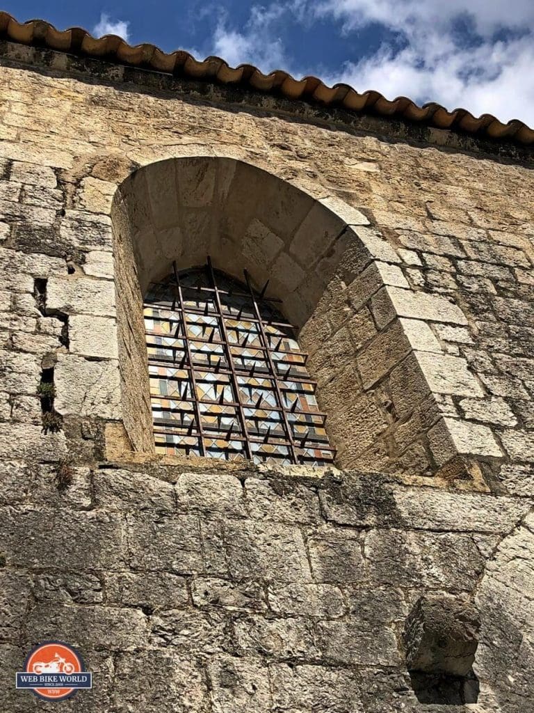 An old stone window in a fort wall in Castellane, France.