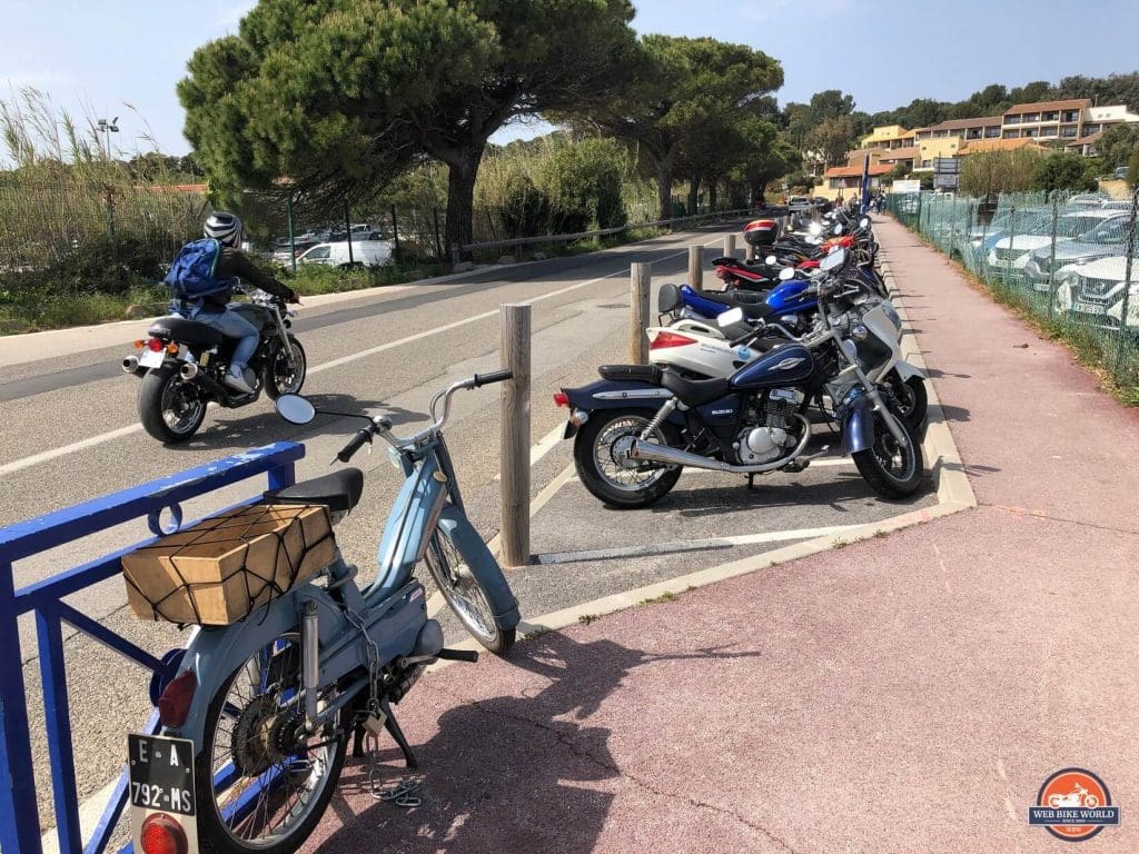 Many motorcycles parked together in France.