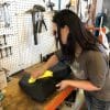 Kate coating my leather seat with Feynlab protection.