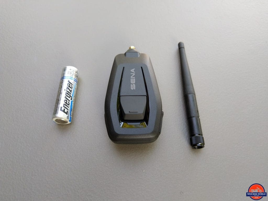 SENA +Mesh Adapter shown with AA battery for scale