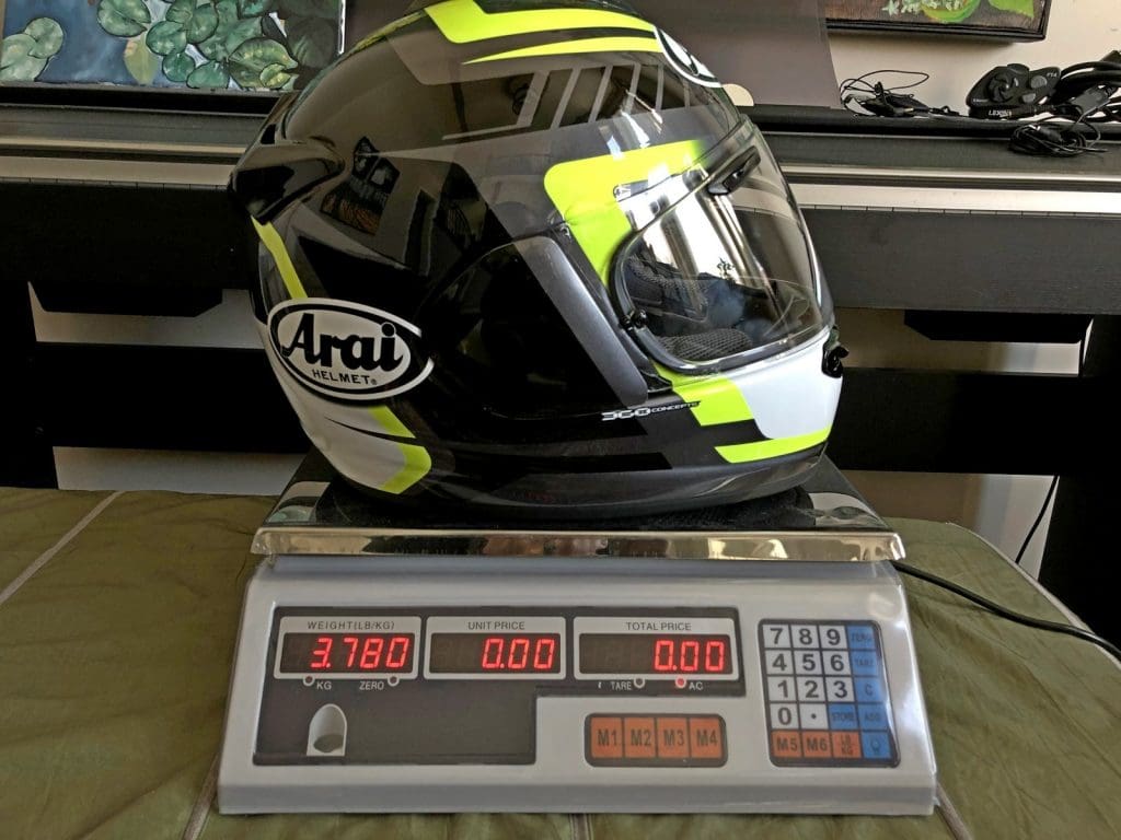 A Snell approved Arai DTX helmet on a scale.