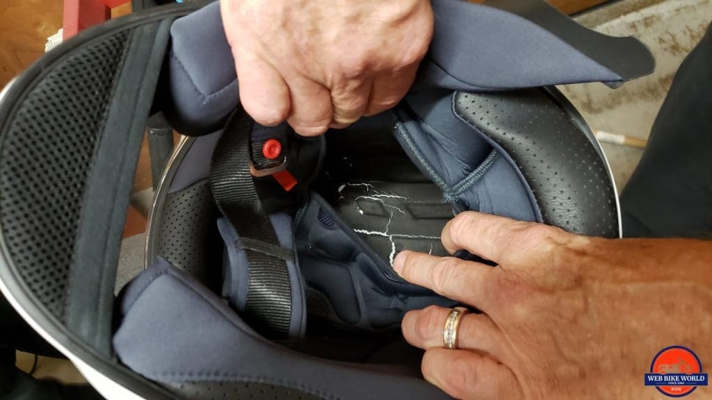 A hole punched through a helmet during Snell testing.